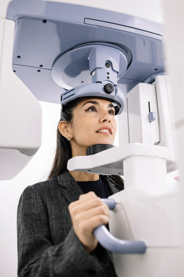 Woman sitting at an x-ray machine in a dentist's office. High quality