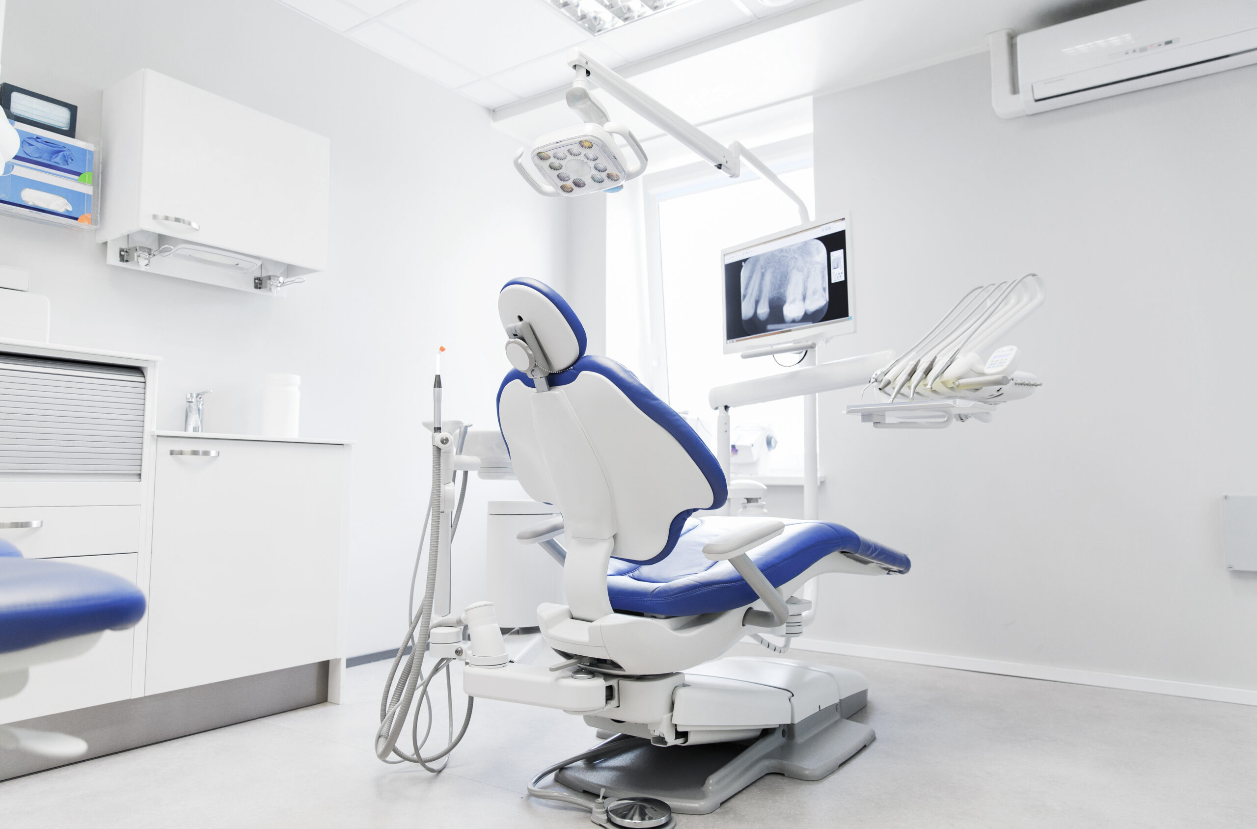 dentistry, medicine, medical equipment and stomatology concept - interior of new modern dental clinic office with chair