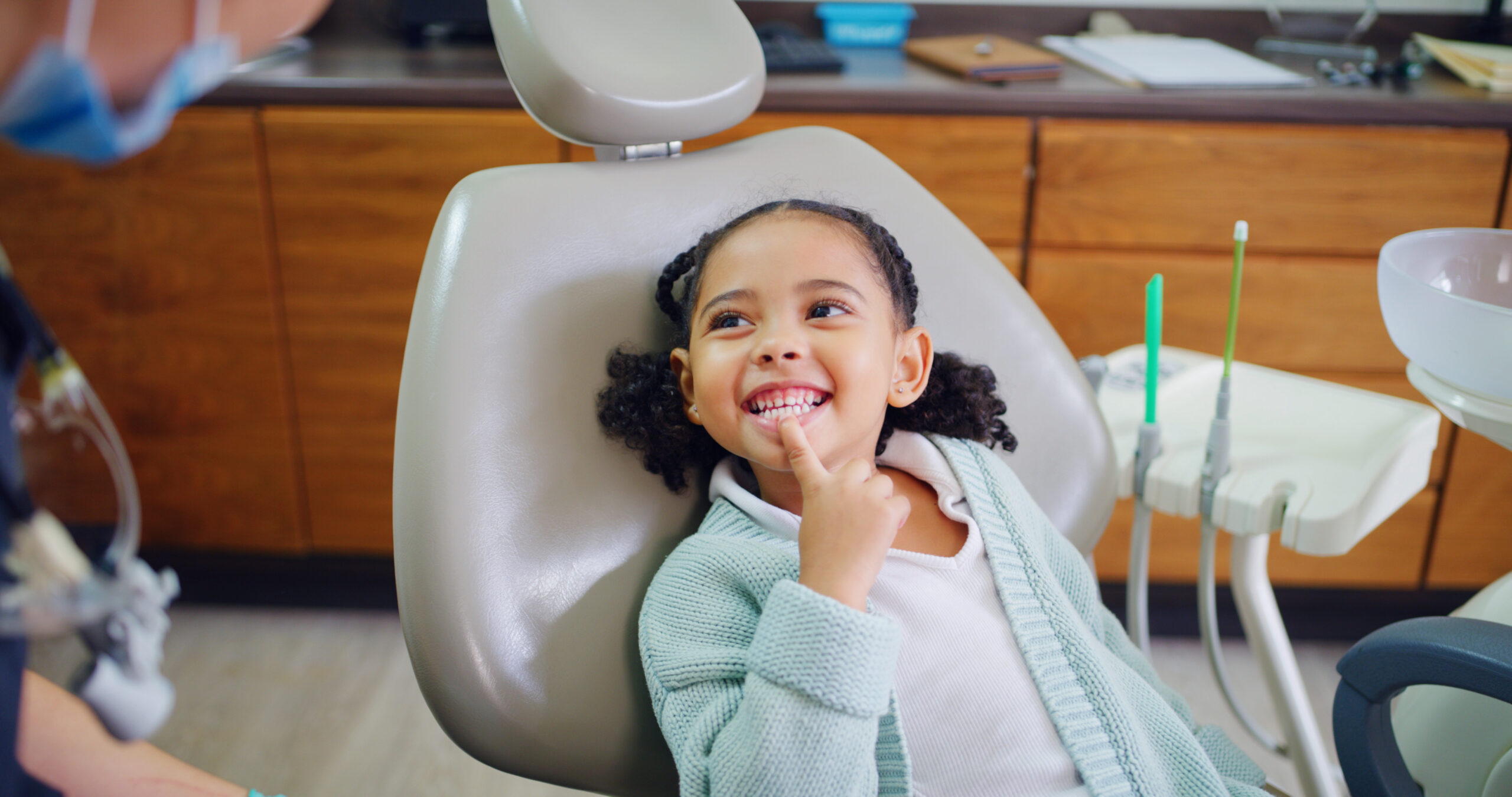 Smile, child and consultation with dentist in office for dental checkup, show cavity and extraction. Happy, kid and paediatric hygienist for oral health, teeth whitening and inspection for cleaning.