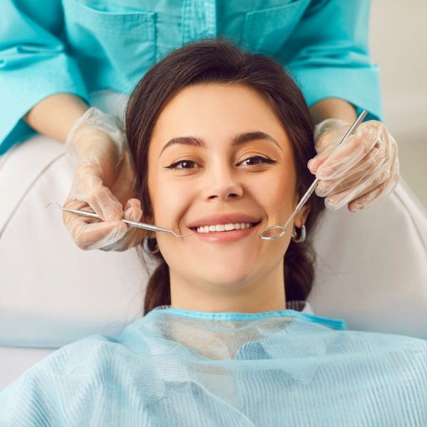 Dentist exam, teeth, gums, dental care exam, happy smiling woman healthy smile at doctor visit in clinic, demonstrating whitening teeth procedure result, satisfied with stomatology clinic service