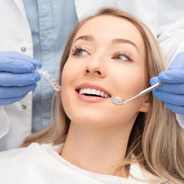 Woman having teeth examined at dentists. Teeth whitening, dental care concept